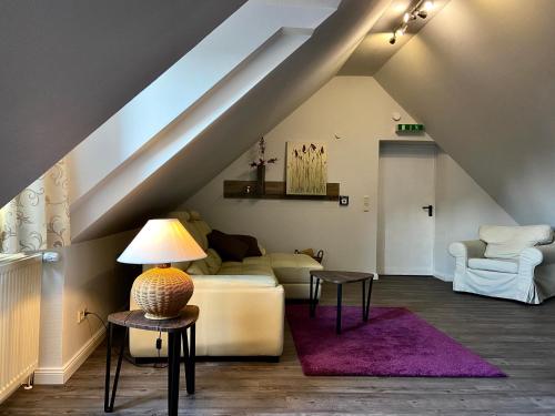 a living room with a couch and a table at Residenz Hotel Neu Wulmstorf in Neu Wulmstorf