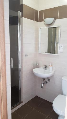 a bathroom with a sink and a toilet at Willa Azur blisko plaży, centrum Mielna in Mielno