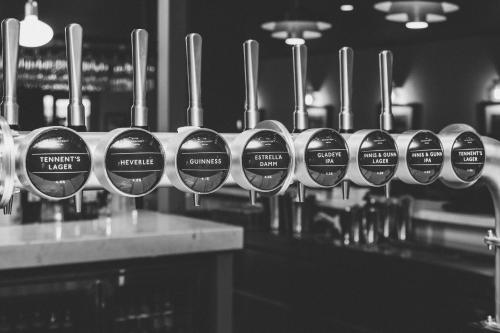 a row of coffee cups lined up on a counter at Broadcroft Hotel in Kirkintilloch