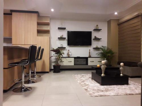a living room with a flat screen tv on a wall at Moderno departamento 3B en Condominio La Victoria in Cuenca