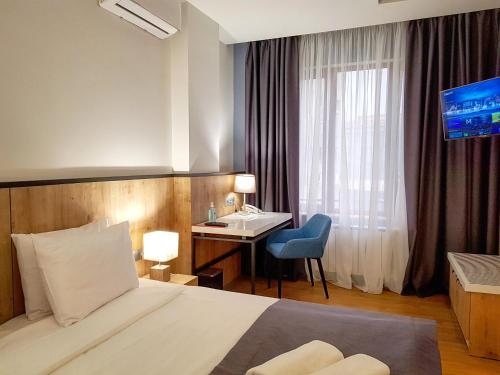 Ένα ή περισσότερα κρεβάτια σε δωμάτιο στο Hotel Alpha
