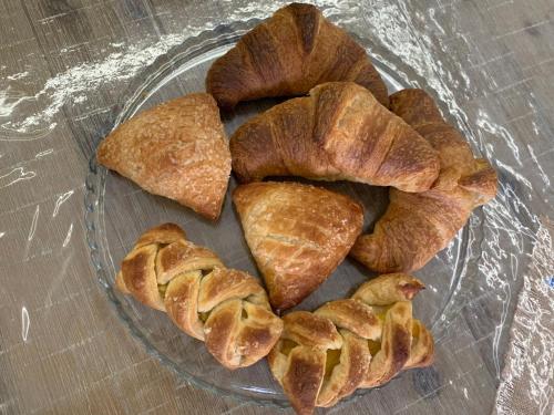 a glass bowl filled with croissants on a table at B&B D'Amari Affittacamere in Palermo