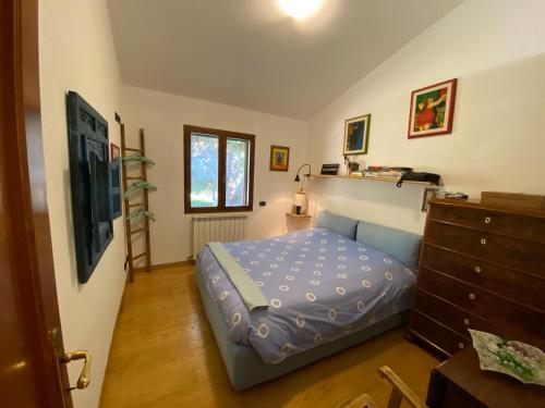 a small bedroom with a bed and a dresser at Casa ai Poggi dell'Argentario in Orbetello
