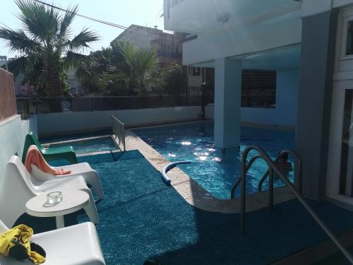 a swimming pool on the roof of a building at Akman Hotel in Kuşadası