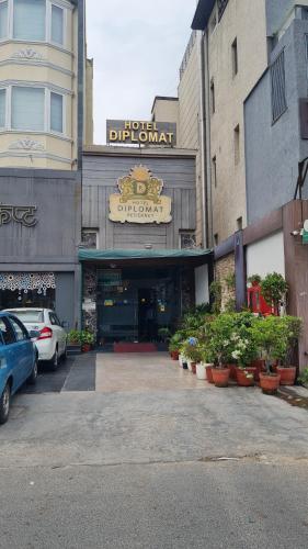 a building with a car parked in a parking lot at Hotel Diplomat Residency in New Delhi