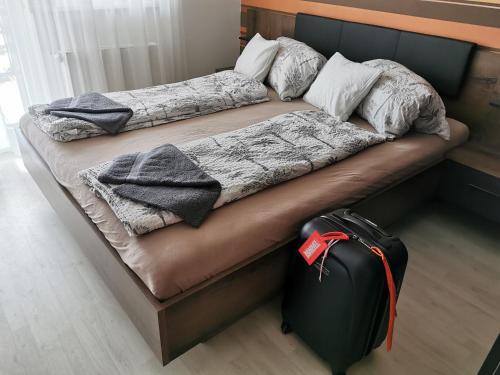 Postel nebo postele na pokoji v ubytování Promenade Apartman