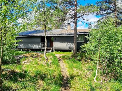 a house in the woods with a path leading to it at 8 person holiday home in SERAL in Hamkoll