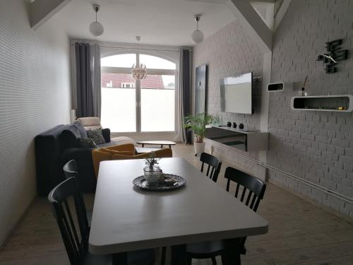 a kitchen and dining room with a table and chairs at Central Loft Apartment in Ueckermünde