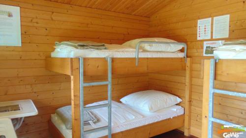 a cabin with three bunk beds in it at Blockhütte am Kegelsberg in Gelenau