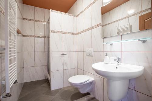瑪麗亞溫泉的住宿－Penzion Bavaria，白色的浴室设有卫生间和水槽。