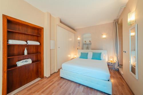 a bedroom with a large bed with blue pillows at Private Villa at Villa al Duomo in Taormina