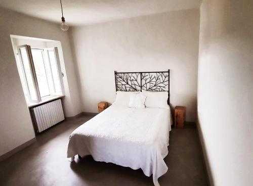 En eller flere senger på et rom på La casa di Montegiardino