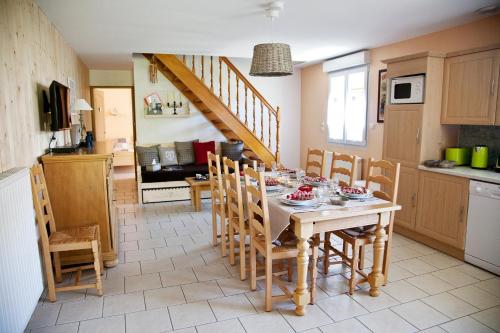 a kitchen and dining room with a table and chairs at Gîtes Estives d'Arrens in Arrens-Marsous