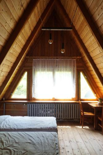 a attic bedroom with two beds and a table at Kosarzówka in Bielsko-Biała