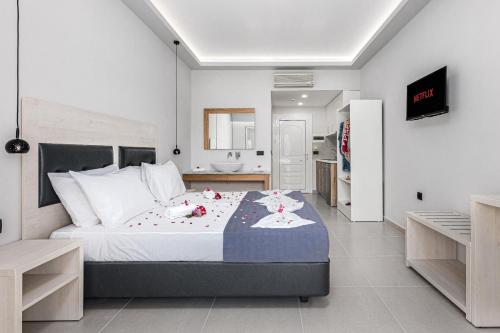 a bedroom with a large bed with flowers on it at Breeze Luxury Rooms in Laganas