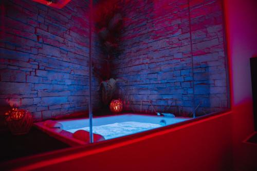 a bath tub in a room with a brick wall at La collina di Capodimonte in Naples