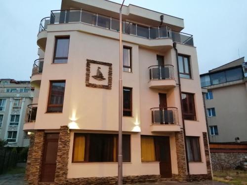 a building with a dog on the side of it at Къща Поморини Несебър in Nesebar