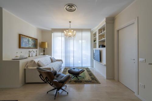 a living room with a couch and a chair at Casa Lazzarini luxury apartment in Pesaro