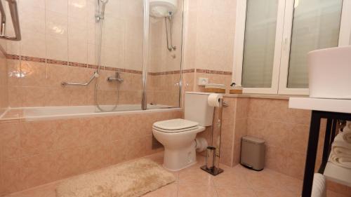 a bathroom with a toilet and a shower and a sink at Etal Luxury Apartment in Dubrovnik