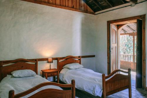 A bed or beds in a room at Casa Rural Lomito del Pino
