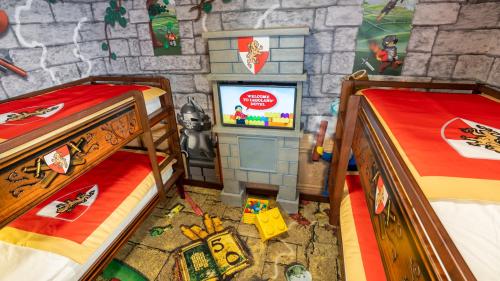 a room with two beds and a tv in it at LEGOLAND Hotel Dubai in Dubai