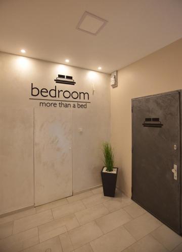 a bathroom more than a bed sign on a wall at Bedroom more than a bed in Zagreb