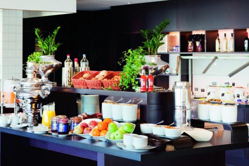 a buffet with fruits and vegetables on a table at Mövenpick Hotel Izmir in Izmir