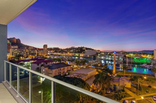 a view of a city at night from a balcony at Allure Hotel & Apartments in Townsville