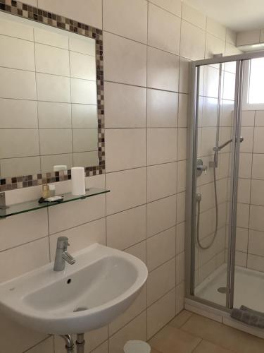 a bathroom with a sink and a shower at Pension N-Ring in Nürburg