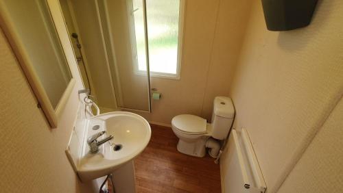 a small bathroom with a sink and a toilet at Domek holenderski święty spokój Bieszczady in Ropienka