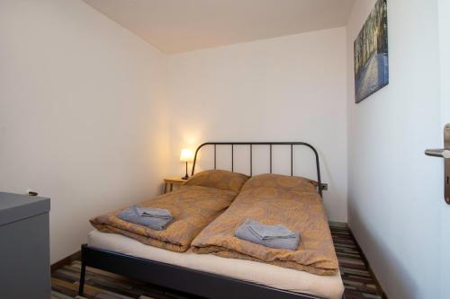 a bedroom with a bed with a blanket on it at Penzion a Bistro Dílna in Třeboň