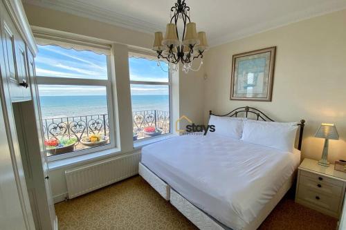 a bedroom with a bed and a large window at Seaview House in Blackpool