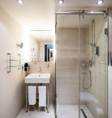 a bathroom with a shower and a sink at BoardingWorld Heidelberg in Heidelberg