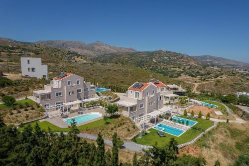 an aerial view of a large house with a swimming pool at Blue Hills Villas in Agia Pelagia