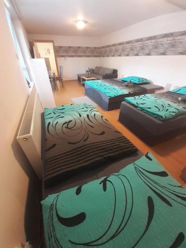 a room with three beds in a room at Apartmán LauMar 2 in Bzenec