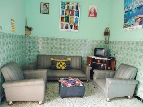 a living room with two couches and a tv at Dar Hkaïem in Sousse