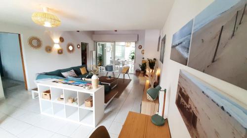 un salon avec un canapé et une table dans l'établissement L'ESCAPADE maison 3 chambres plus mezzanine 8 à 10 personnes, à Saint-Jean-de-Monts