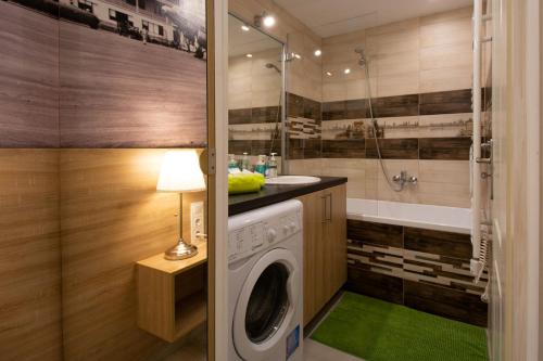 a bathroom with a washing machine and a shower at Castle Suite in Budapest