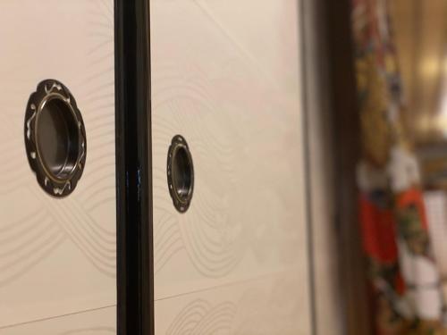 a door with two handles on a refrigerator at Temple Lodging Shukubo Kakurinbo in Minobu
