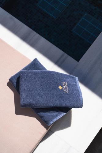 a blue tie sitting on top of a table at Lithos Luxury Suites in Tinos Town
