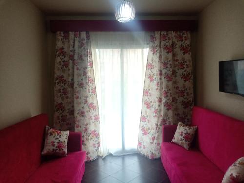 a living room with two pink couches and a window at شاليهات بورتو مطروح فيو بحر Porto Matrouh Sea View Families Only in Marsa Matruh
