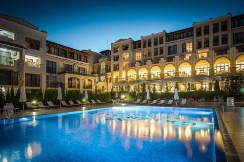 a large swimming pool in front of a building at Apartment Beach Kavatsi in Sozopol