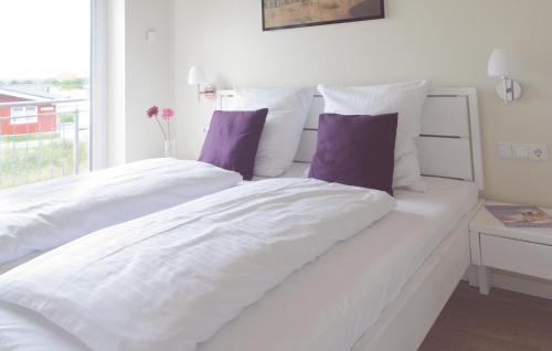 ダゲビュルにある3 Bedroom Cozy Home In Dagebllの白いベッド(白いシーツ、紫色の枕付)