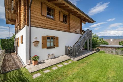 a small house with a porch and a stairway at Bergchalet Fuchsberger in Verano