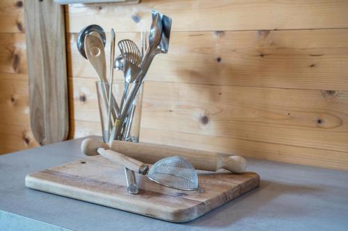 a bunch of kitchen utensils sitting on a cutting board at Bergchalet Fuchsberger in Verano
