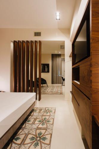 a bedroom with a bed and a flat screen tv at Palazzo della Fontana in Matera