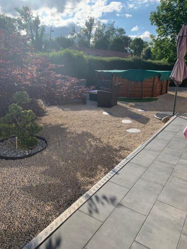 a garden with a patio and a lawn at B&B Chez Jaika Chambre d hotes in Belleville-en-Beaujolais