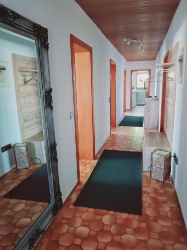 a hallway of a house with a mirror and a door at FEWO Paternoster in Regen