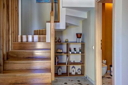 a staircase in a home with wooden steps at Tessera Villas & Studios Collection in Gouvia