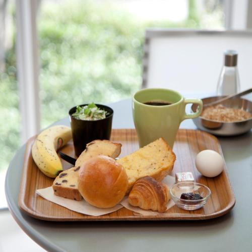 a tray with bread and eggs and a cup of coffee at 7 Days Hotel Plus in Kochi